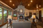 Soaring ceilings and massive stone fireplace in great room